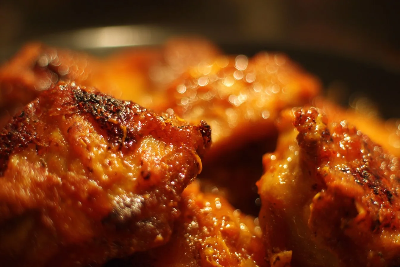 Plate of spicy Buffalo Chicken wings garnished with celery and blue cheese dressing