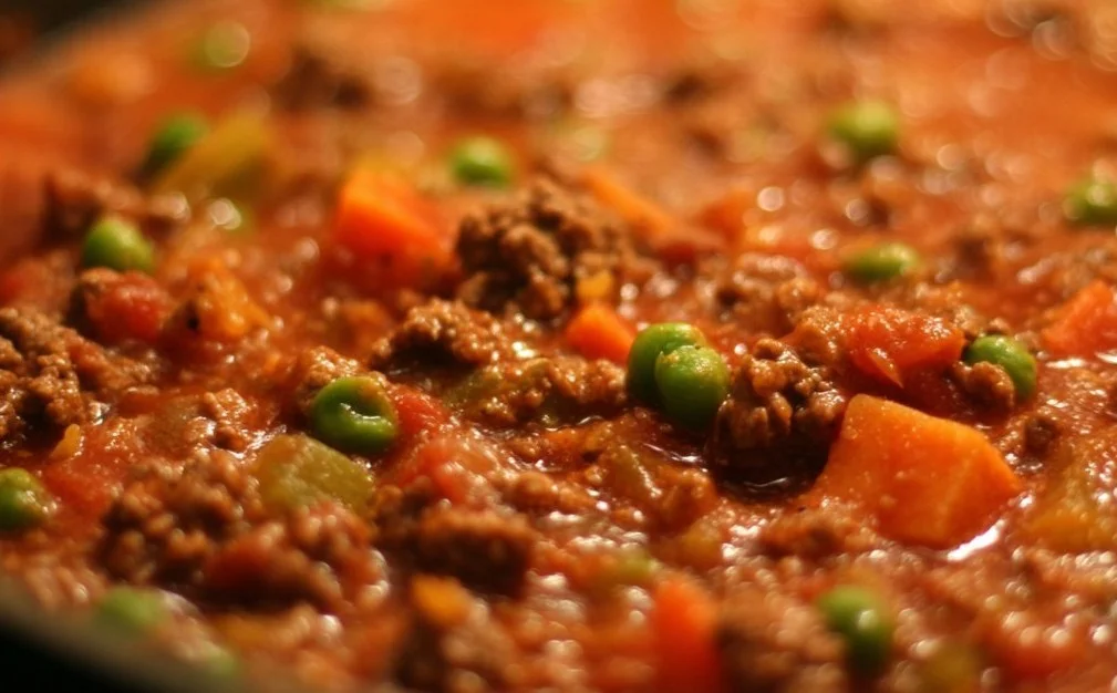 A flavorful ground beef dinner served with vegetables and herbs.