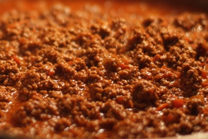 A delicious ground beef recipe served on a plate with fresh vegetables.