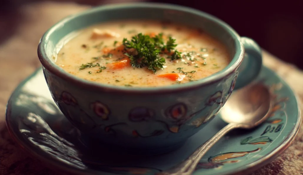 Bowl of homemade cream of chicken soup garnished with herbs