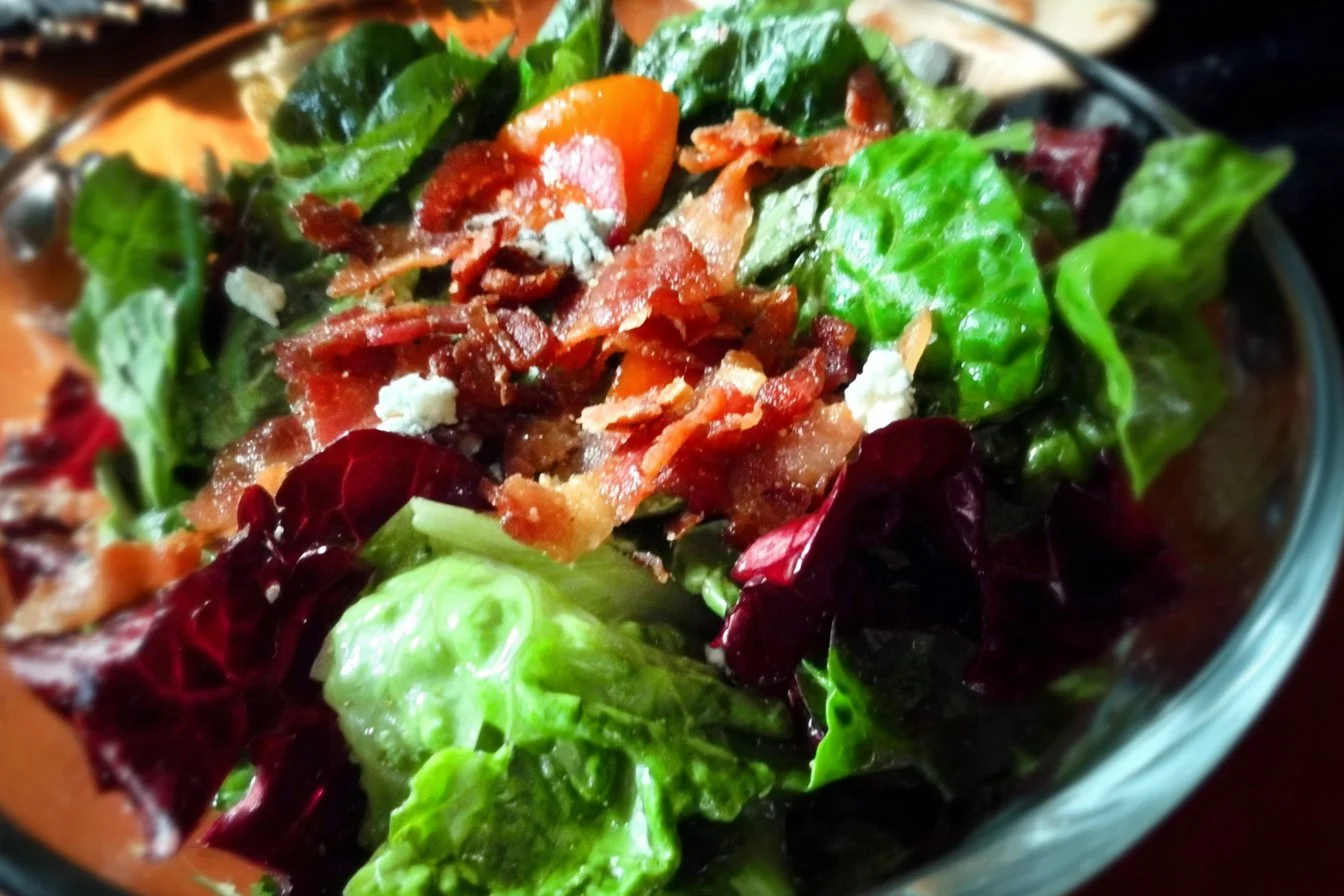 A vibrant bowl of the best salad ever, featuring fresh vegetables and delicious dressing.