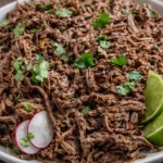 Delicious Beef Barbacoa served in a taco with fresh toppings