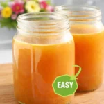 Homemade beef bone broth simmering in a pot with vegetables and spices.