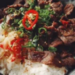 Delicious Beef Bowl with tender beef and fresh toppings over rice