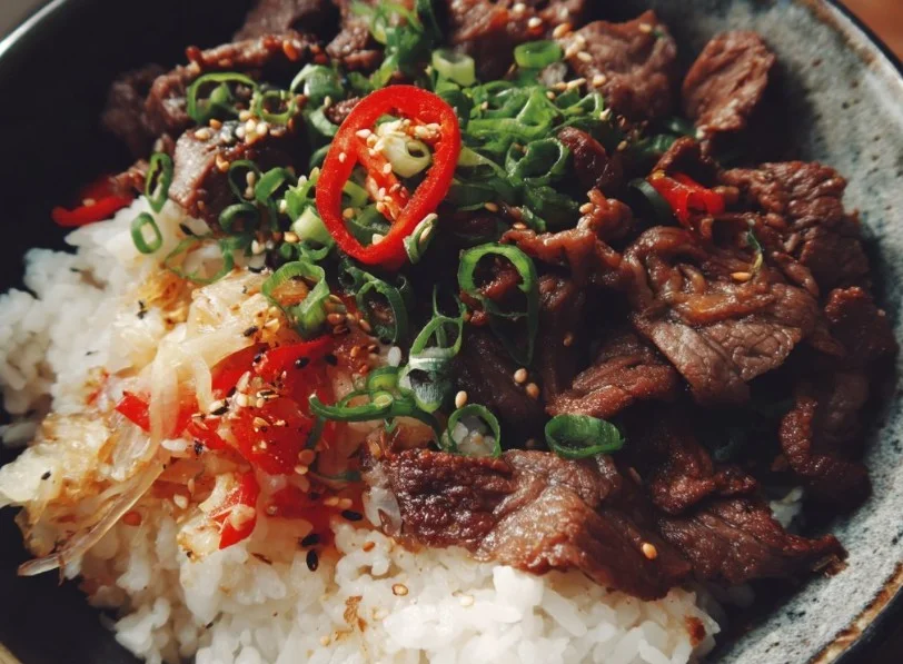 Delicious Beef Bowl with tender beef and fresh toppings over rice
