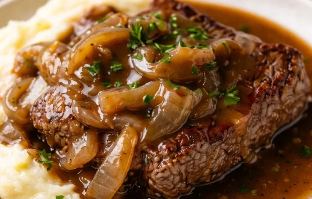 Juicy beef cube steak cooked with herbs and spices on a plate