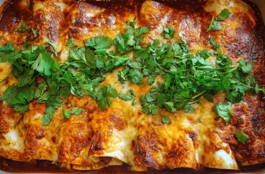 Plate of beef enchiladas topped with cheese and salsa