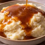 Homemade Beef Gravy poured over mashed potatoes