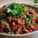 A savory dish made with beef mince, herbs, and vegetables in a skillet.