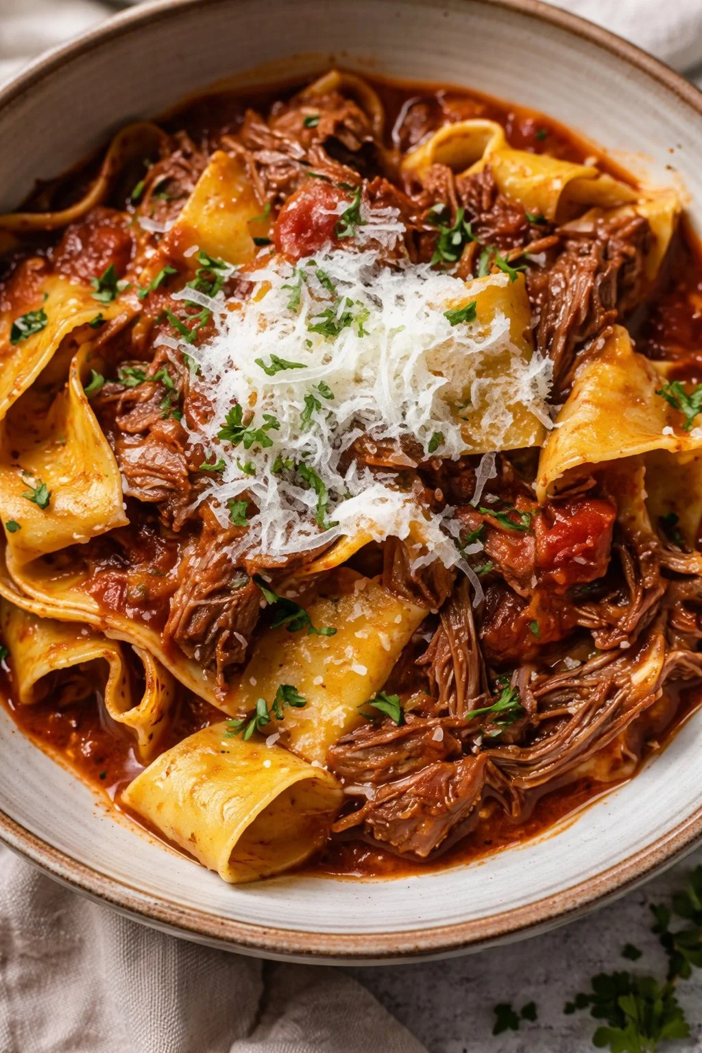 Delicious bowl of Beef Ragu with pasta and herbs, a classic Italian recipe.