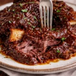 Deliciously cooked beef ribs served on a plate with side dishes.