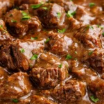 Crock Pot Beef Tips served in a bowl with gravy and vegetables.