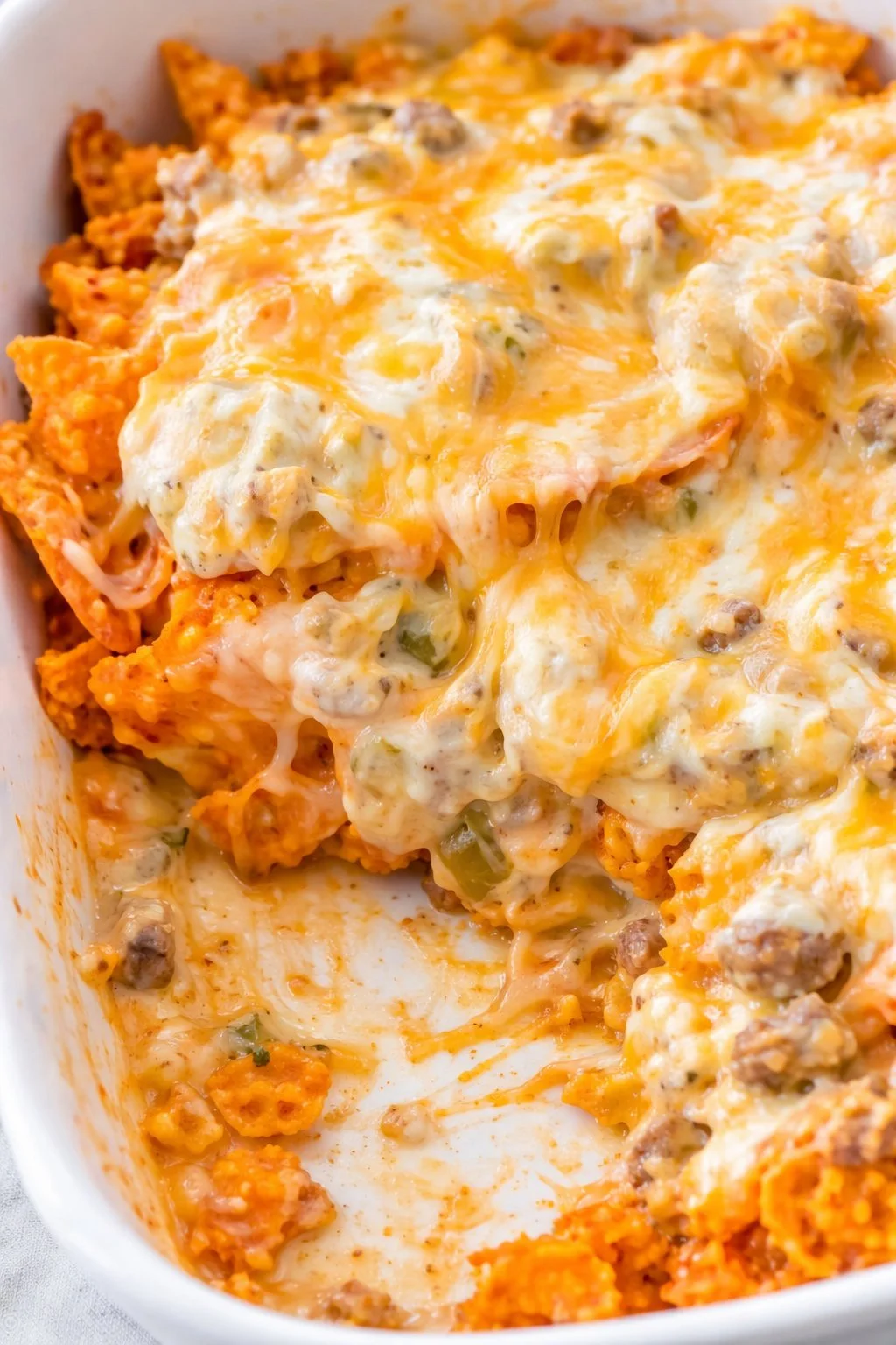 Delicious Doritos Casserole with Ground Beef topped with cheese and Doritos chips