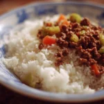 A delicious plate of ground beef and rice with vegetables.