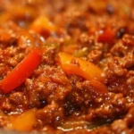 A savory ground beef dish served with vegetables and herbs