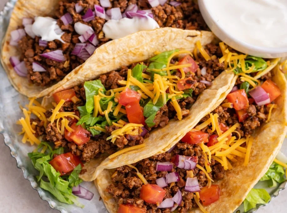 Delicious ground beef tacos topped with fresh ingredients and salsa