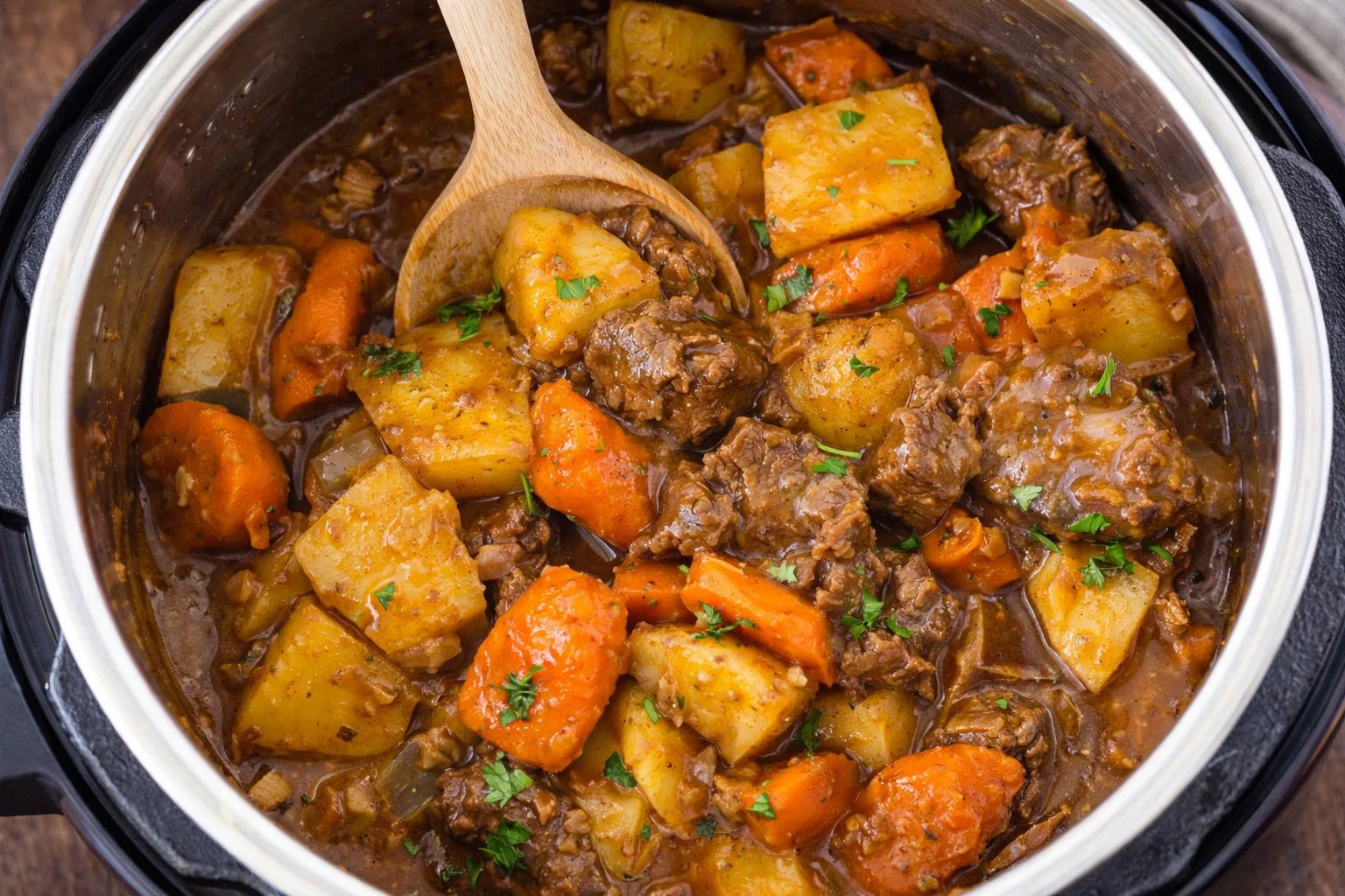 A hearty bowl of Instant Pot beef stew with vegetables and herbs