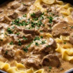 Delicious Instant Pot Beef Stroganoff served with noodles and garnished with parsley.