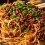 Delicious bowl of Mongolian Beef Noodles with vegetables and sauce