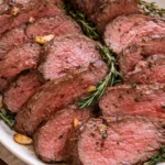 Juicy oven roasted beef tenderloin served with herbs and spices