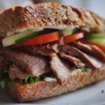 Mouthwatering roast beef sandwich on a toasted bun with fresh vegetables