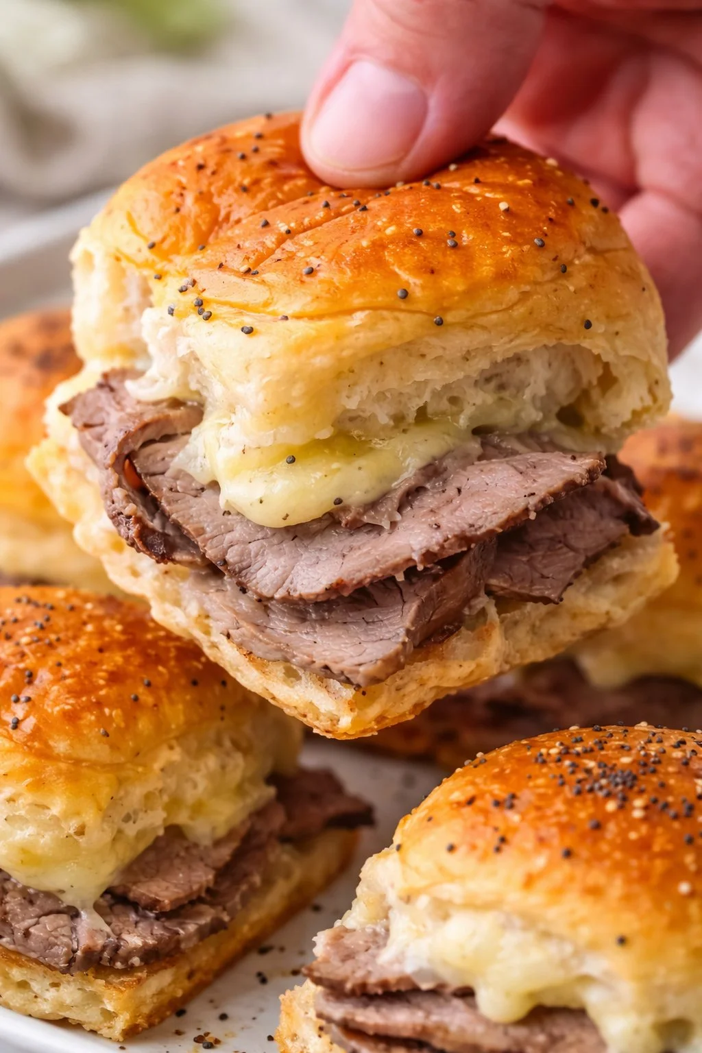 Roast beef sliders served on Hawaiian rolls with toppings.