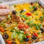Delicious taco dip with ground beef served in a bowl
