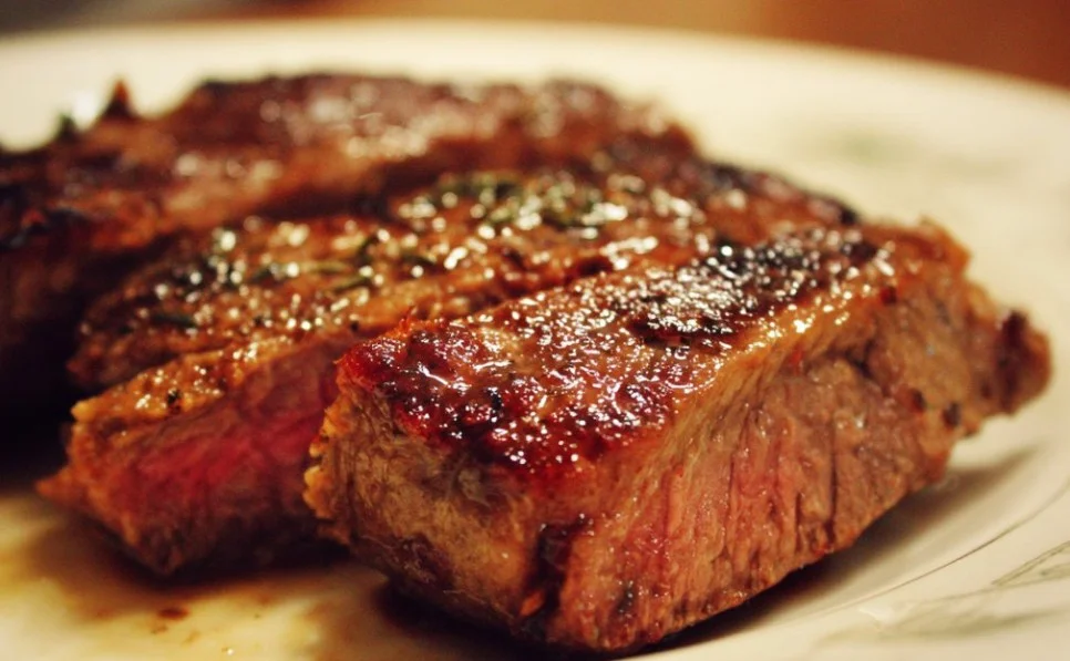 Cooked Beef Bottom Round Steak served with vegetables on a plate