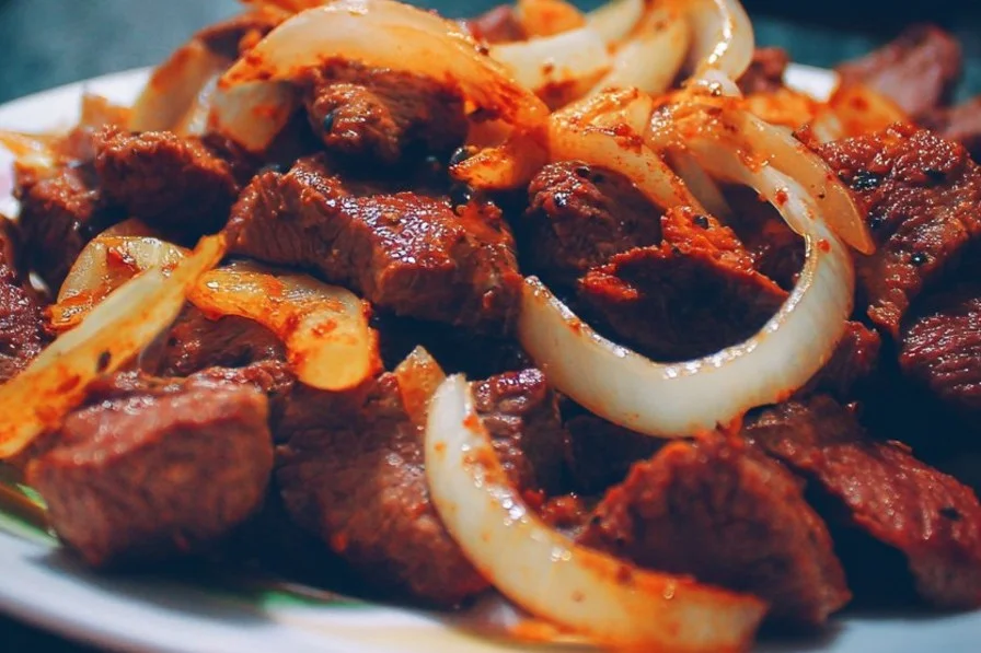 Delicious beef dish served with fresh vegetables and herbs.