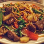 Colorful beef stir-fry with vegetables in a sizzling wok.