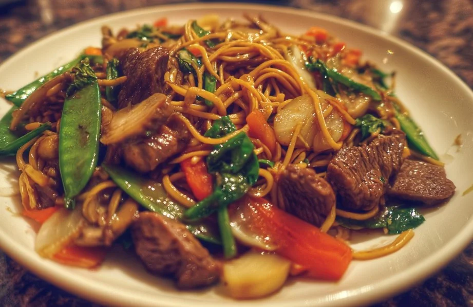 Colorful beef stir-fry with vegetables in a sizzling wok.
