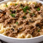 Delicious Beef Stroganoff served with noodles and garnished with parsley.