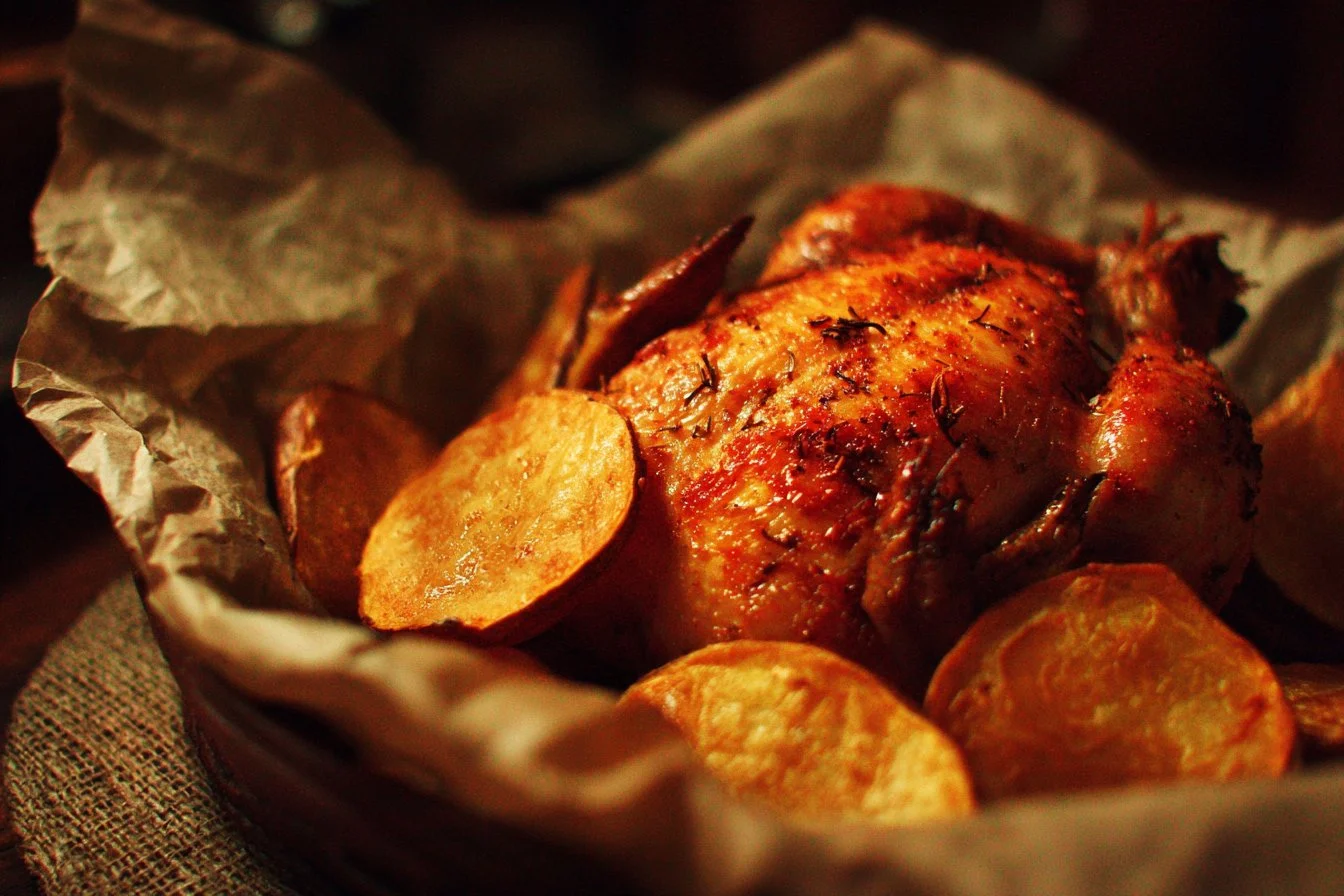 Plate of chicken and sweet potato dish garnished with herbs