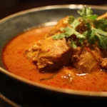 A delicious bowl of homemade chicken curry served with rice.