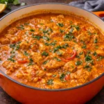 Delicious chicken curry simmering in a traditional clay pot