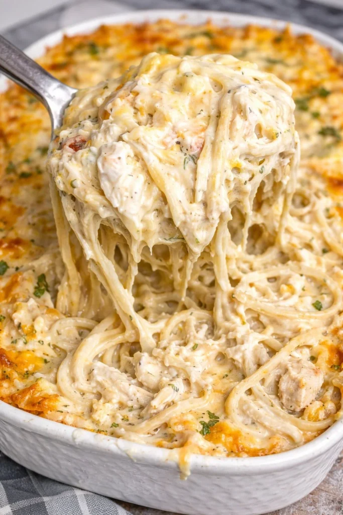 Creamy Chicken Tetrazzini dish topped with cheese and parsley on a plate