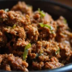Crockpot ground beef dish ready to serve with vegetables and spices