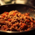 Gluten-free ground beef recipe served on a plate with fresh vegetables.