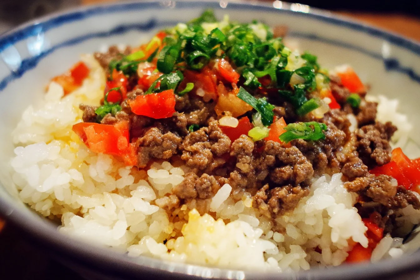 A delicious Ground Beef Rice Bowl topped with fresh veggies and spices