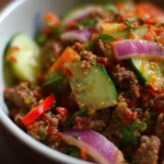 Delicious ground beef salad garnished with vegetables served on a plate