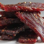 Homemade beef jerky prepared with spices and herbs