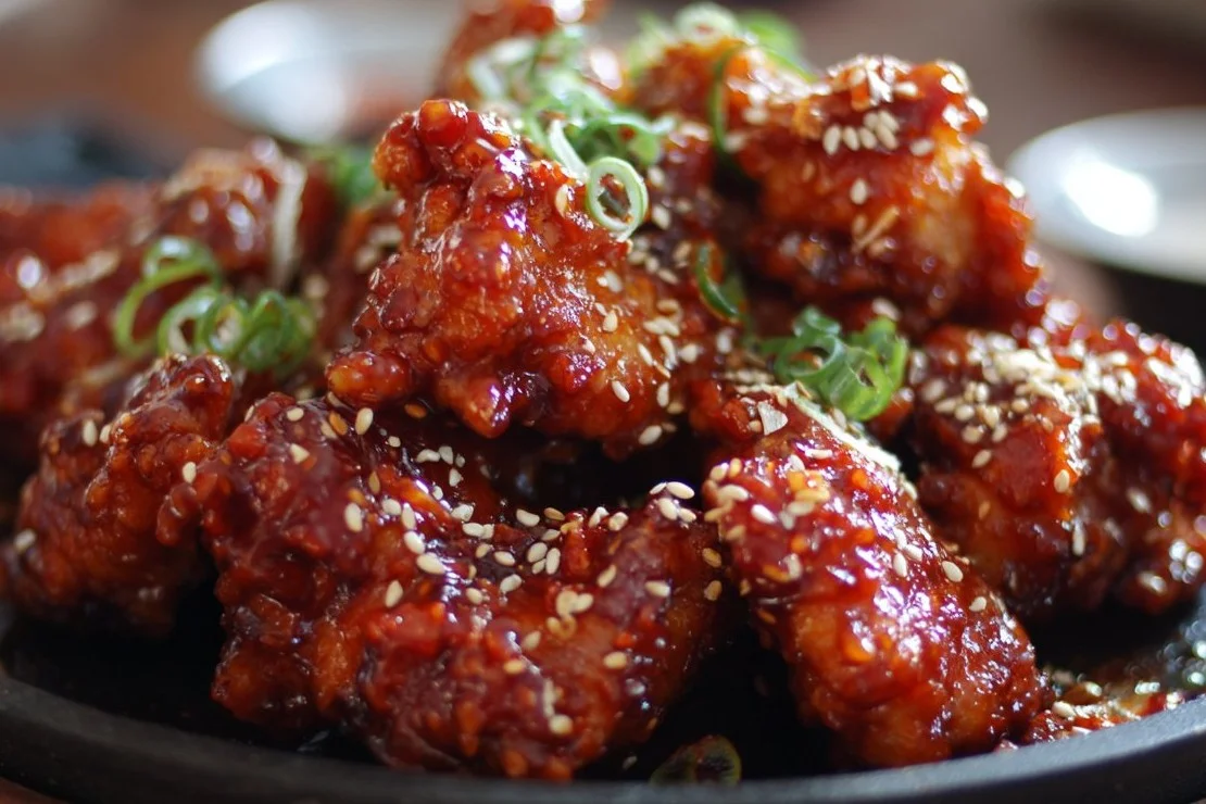 Delicious Korean Chicken garnished with sesame seeds and green onions