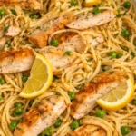 Delicious Lemon Chicken Pasta topped with parsley and lemon slices.