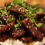 Delicious plate of Mongolian Beef stir-fry with vegetables and rice