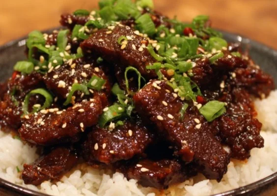 Delicious plate of Mongolian Beef stir-fry with vegetables and rice
