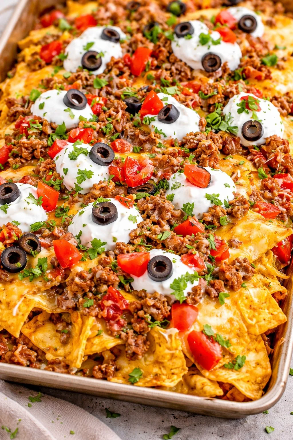 Deliciously loaded sheet pan nachos with toppings ready to serve.