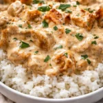 Delicious Smothered Chicken served over fluffy rice in a hearty meal.