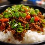 Plate of teriyaki ground beef served over rice with vegetables