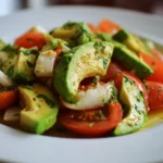 Delicious avocado salad with fresh vegetables and dressing