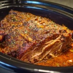 Delicious beef brisket cooked in a crock pot, served with sides.